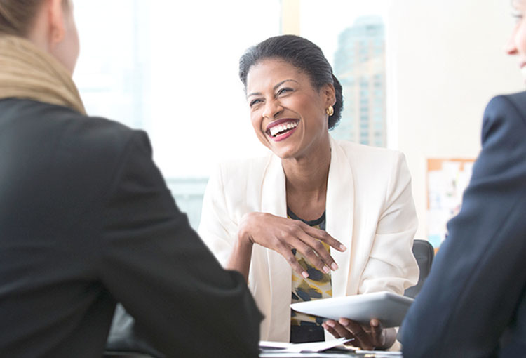 A female TD colleague meets with two women entrepreneurs to discuss their financial options.
